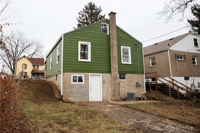 back of house with central AC