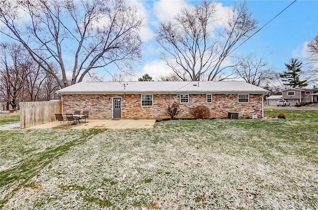 rear view of house with a patio area and a lawn