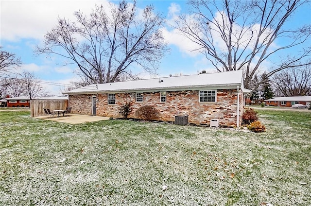 rear view of house with a patio and a lawn