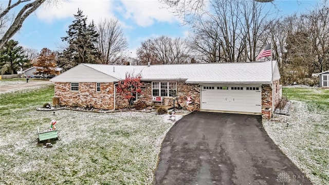 single story home with a front yard and a garage