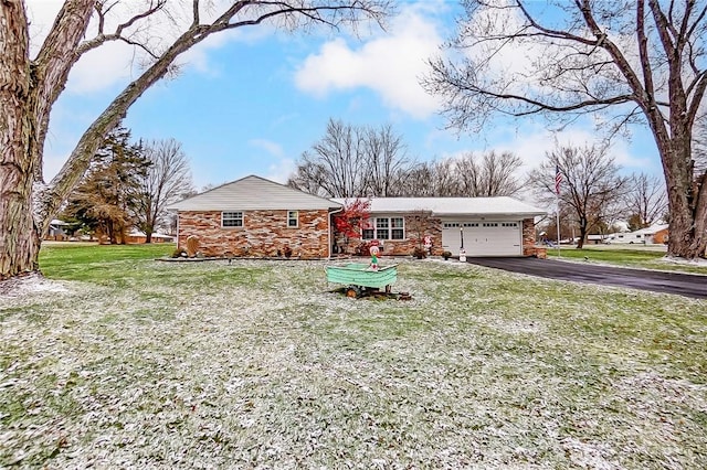 ranch-style home featuring a garage and a front lawn