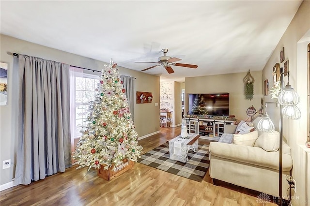 living room with hardwood / wood-style floors and ceiling fan