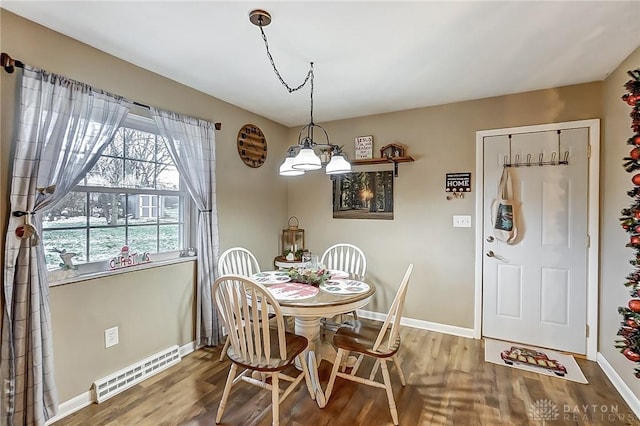 dining space featuring a notable chandelier and hardwood / wood-style flooring