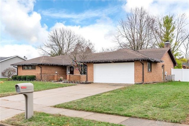 ranch-style house featuring a garage and a front yard