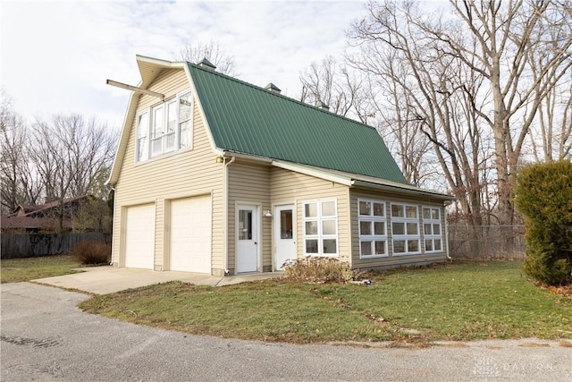 view of front of property with a front yard and a garage