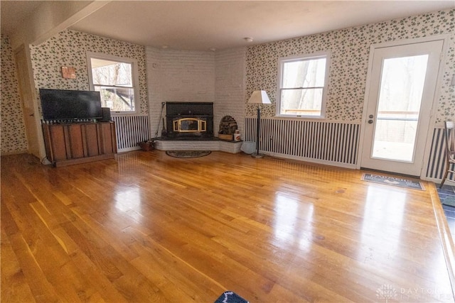 unfurnished living room featuring a fireplace and wood-type flooring