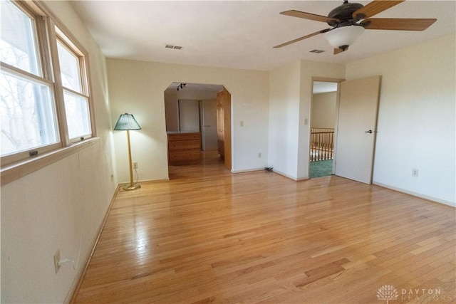 empty room featuring ceiling fan and light hardwood / wood-style floors