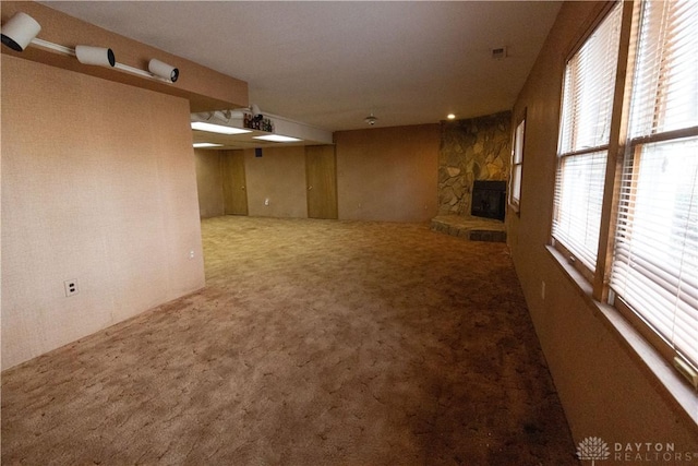 unfurnished living room featuring a fireplace and carpet floors