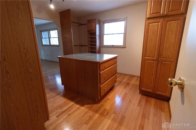 interior space with a kitchen island and light hardwood / wood-style floors