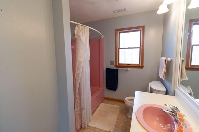 full bathroom with tile patterned flooring, sink, shower / bathtub combination with curtain, and toilet