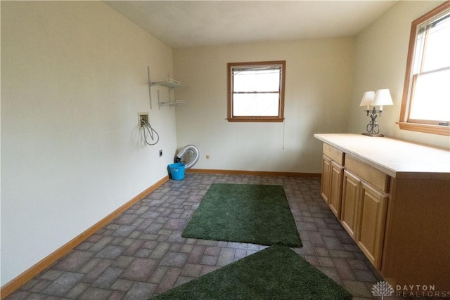 washroom with cabinets, washer hookup, plenty of natural light, and electric dryer hookup