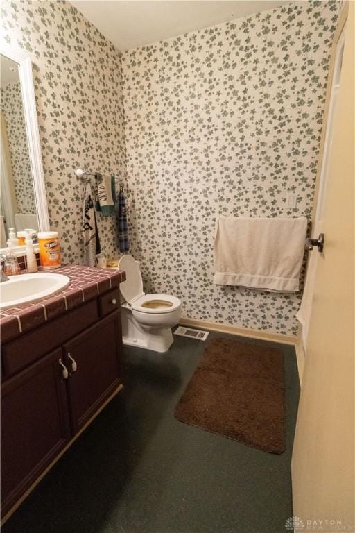 bathroom featuring vanity and toilet