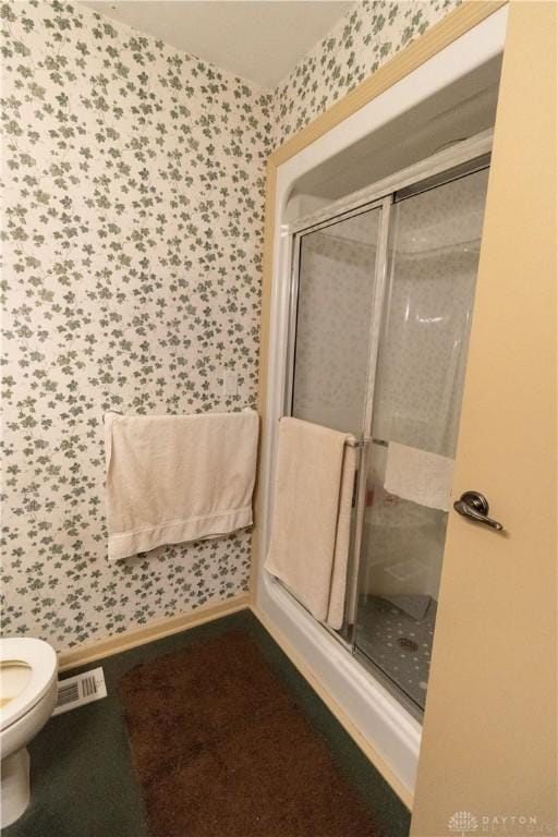 bathroom with toilet and walk in shower