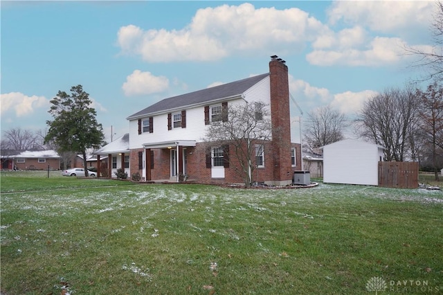 view of front facade featuring central air condition unit and a front lawn