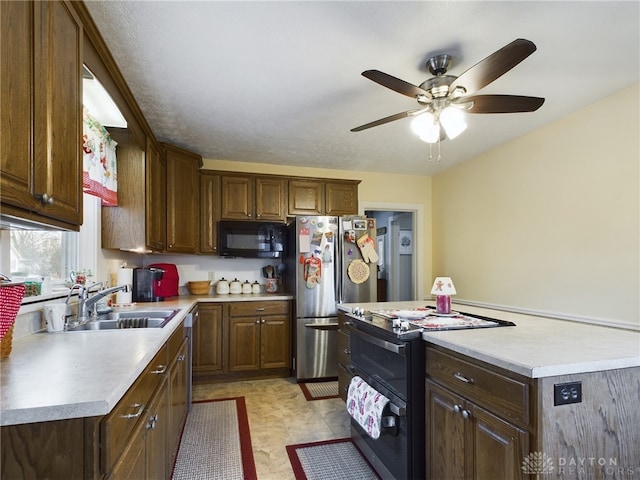 kitchen featuring ceiling fan, sink, black appliances, and a textured ceiling