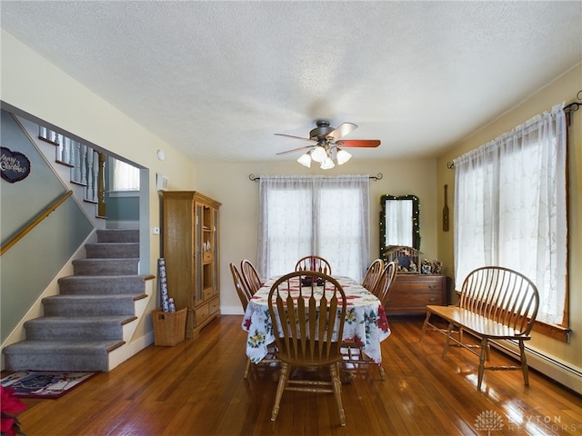 dining room featuring a textured ceiling, ceiling fan, and dark wood-type flooring