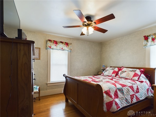 bedroom with ceiling fan and light hardwood / wood-style flooring