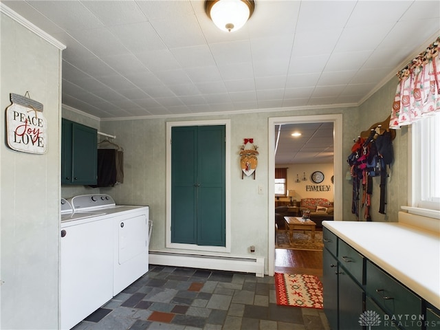 laundry room featuring washer and dryer, cabinets, ornamental molding, and a baseboard heating unit