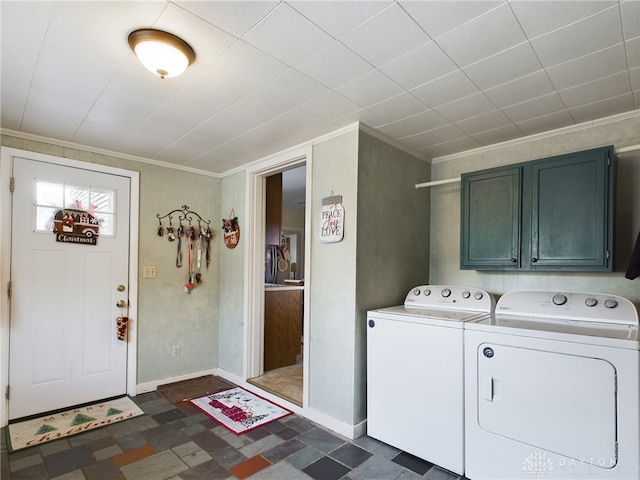 clothes washing area featuring separate washer and dryer, cabinets, and ornamental molding