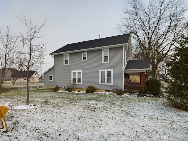 view of snow covered rear of property