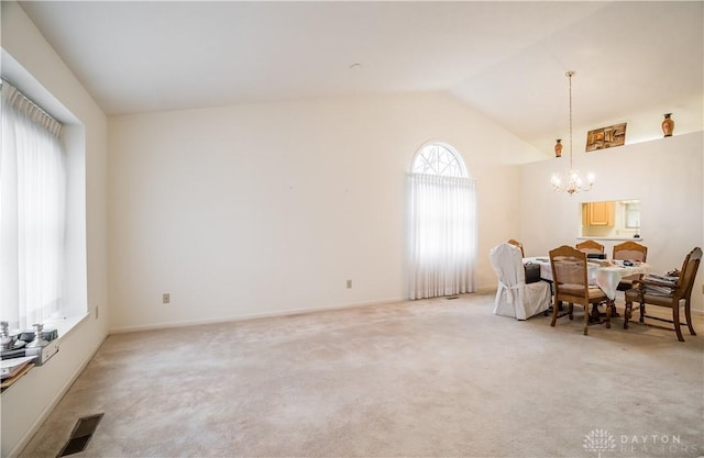 sitting room featuring light colored carpet, vaulted ceiling, and a notable chandelier