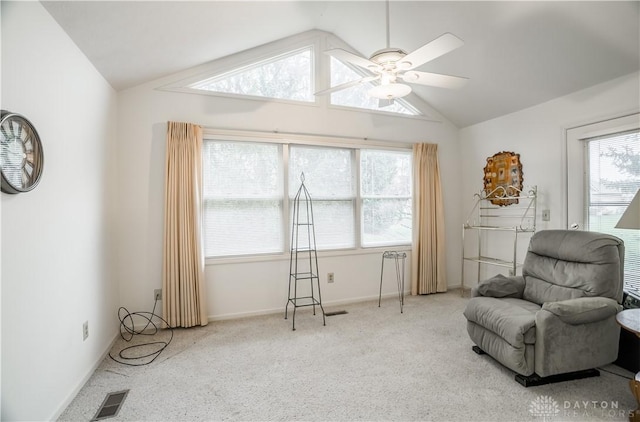 living area with light carpet, plenty of natural light, ceiling fan, and lofted ceiling