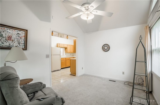 living area featuring ceiling fan and high vaulted ceiling