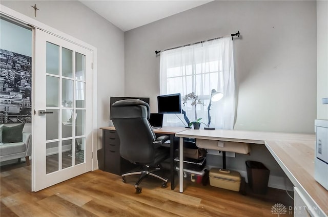 home office with hardwood / wood-style floors and french doors