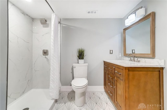 bathroom featuring a shower with curtain, vanity, toilet, and tile patterned floors