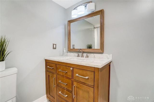 bathroom featuring vanity and toilet