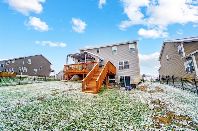 rear view of property featuring a lawn and a wooden deck