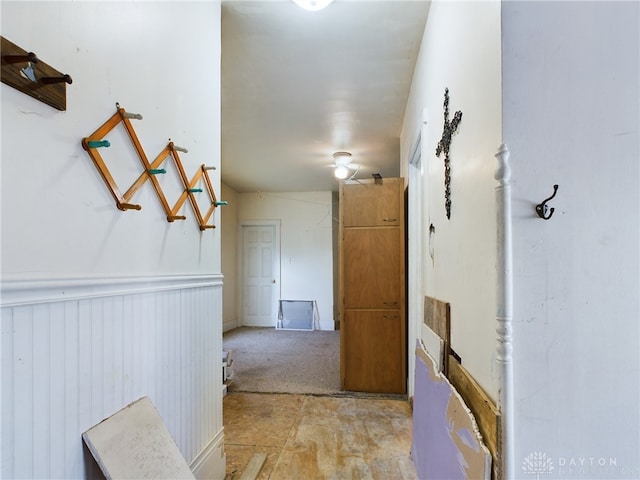 hallway featuring wainscoting