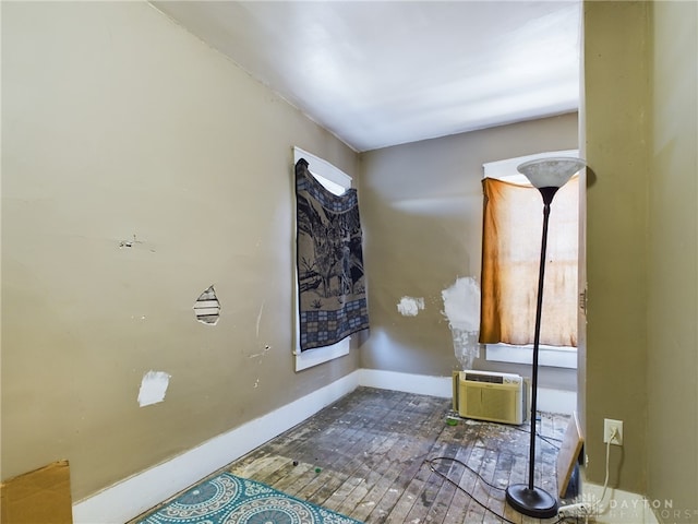 interior space featuring baseboards and a wall mounted AC