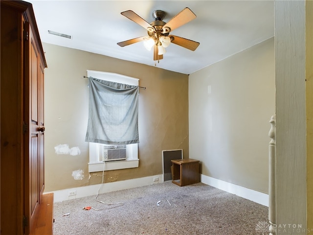 unfurnished bedroom featuring ceiling fan, cooling unit, carpet flooring, visible vents, and baseboards