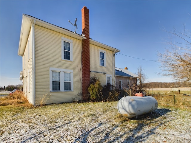 view of side of home with a chimney