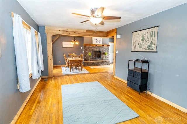 interior space with hardwood / wood-style floors and ceiling fan with notable chandelier