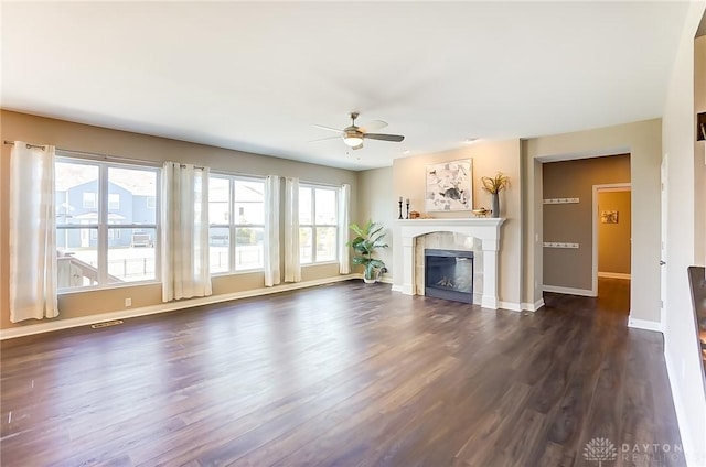 unfurnished living room with ceiling fan and dark hardwood / wood-style floors