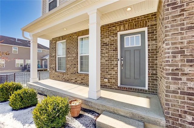 view of exterior entry with a porch