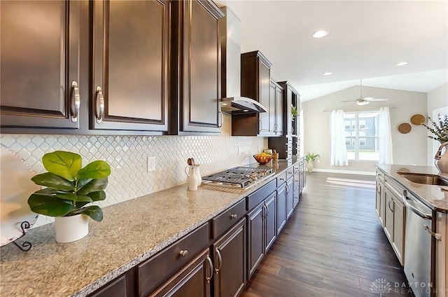 kitchen featuring lofted ceiling, backsplash, sink, dark hardwood / wood-style floors, and appliances with stainless steel finishes