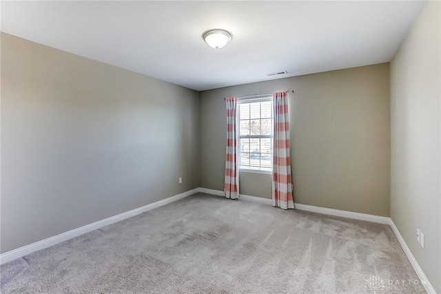 unfurnished room with light carpet