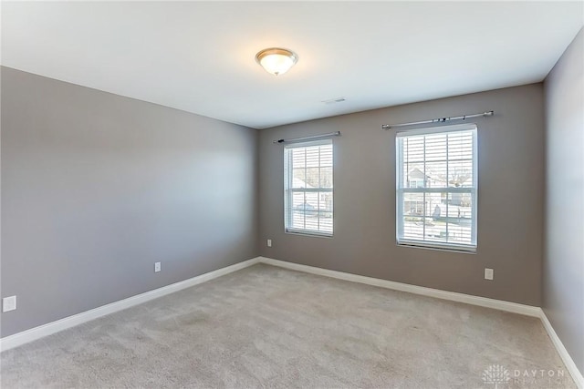 unfurnished room with light colored carpet