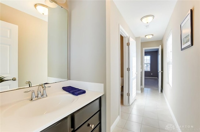 bathroom featuring tile patterned flooring, vanity, and toilet