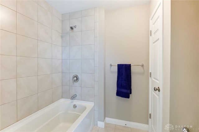 bathroom featuring tile patterned floors and tiled shower / bath