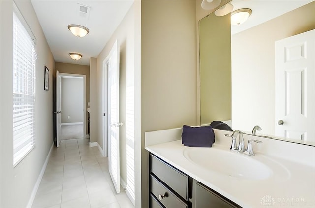 bathroom with tile patterned flooring, plenty of natural light, and vanity