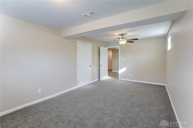 carpeted spare room featuring ceiling fan