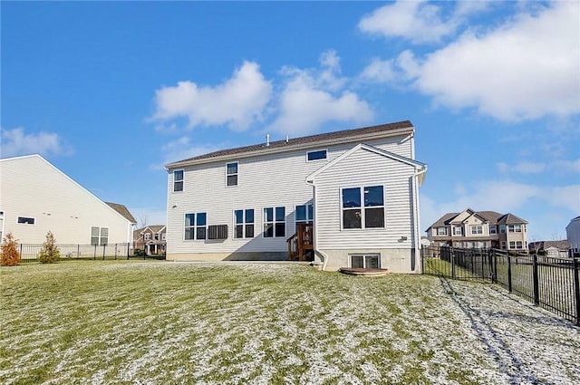 rear view of property featuring a yard