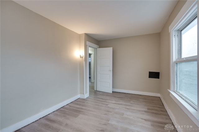 spare room with light hardwood / wood-style floors