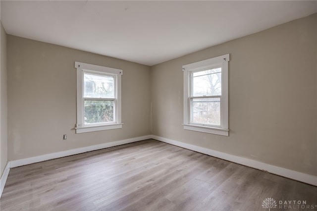 unfurnished room with light hardwood / wood-style floors and a healthy amount of sunlight