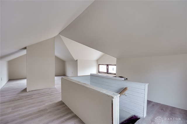 bonus room featuring light hardwood / wood-style flooring and lofted ceiling