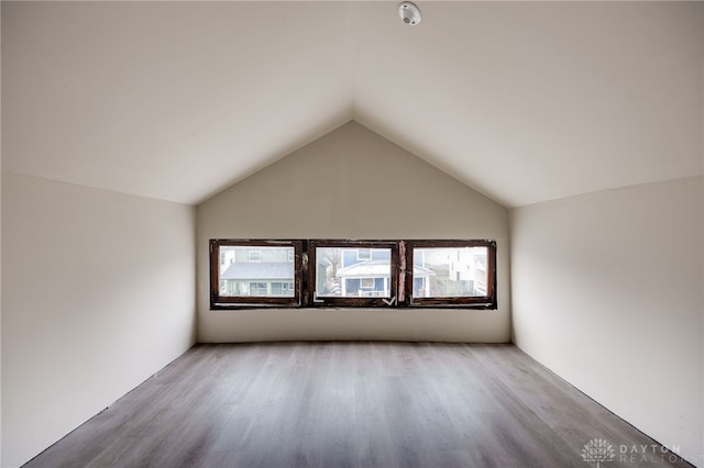 interior space with vaulted ceiling and light hardwood / wood-style flooring